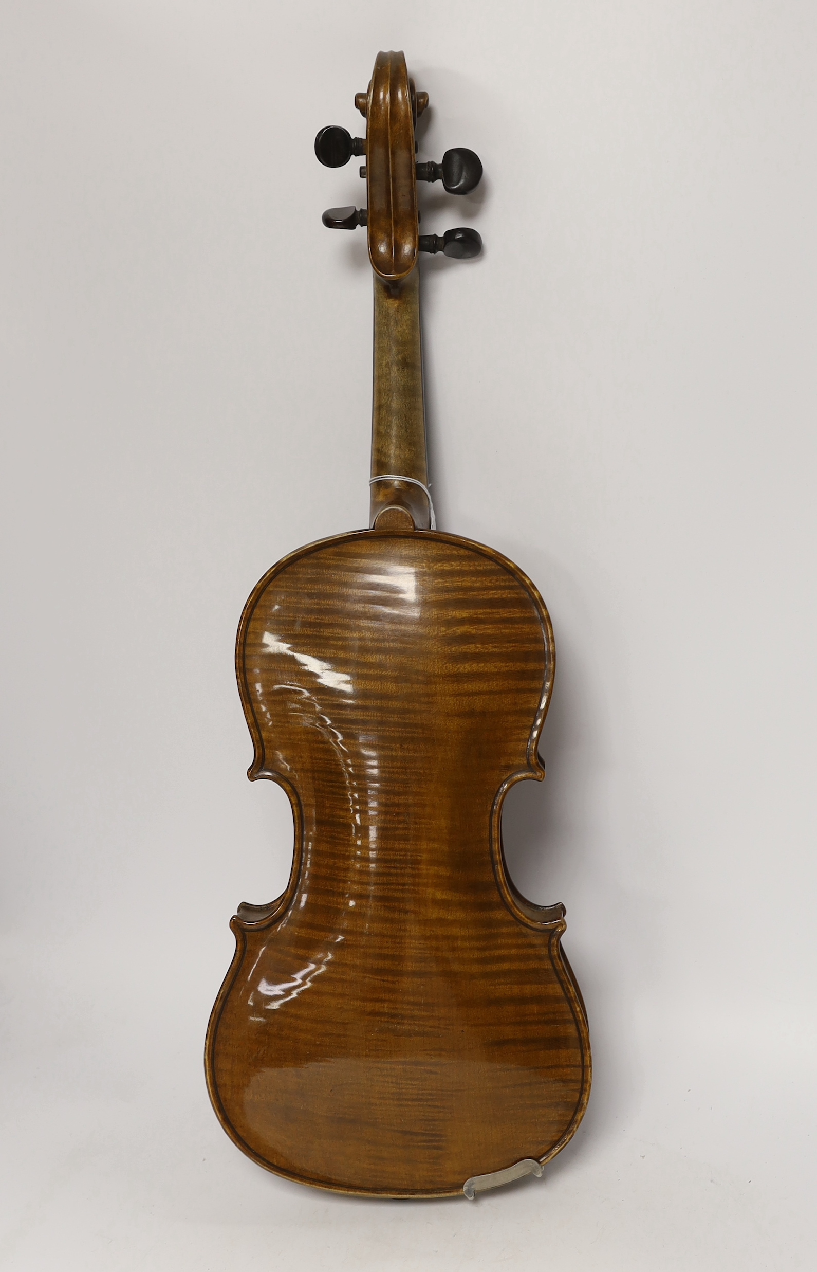 A cased early twentieth century violin by Rudolph Raymond, with maker’s label inside the body stating ‘made 1904’, body 36cm, in a good case with a label for W.E. Hills & Sons, Violin Makers, 140 New Bond St. London